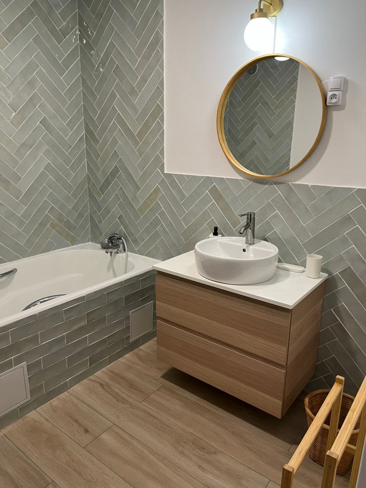 This is an example of a large modern master bathroom in Paris with shaker cabinets, light wood cabinets, an undermount tub, a shower/bathtub combo, a two-piece toilet, green tile, ceramic tile, green walls, ceramic floors, a trough sink, laminate benchtops, beige floor, an open shower, a single vanity, a floating vanity and wood walls.