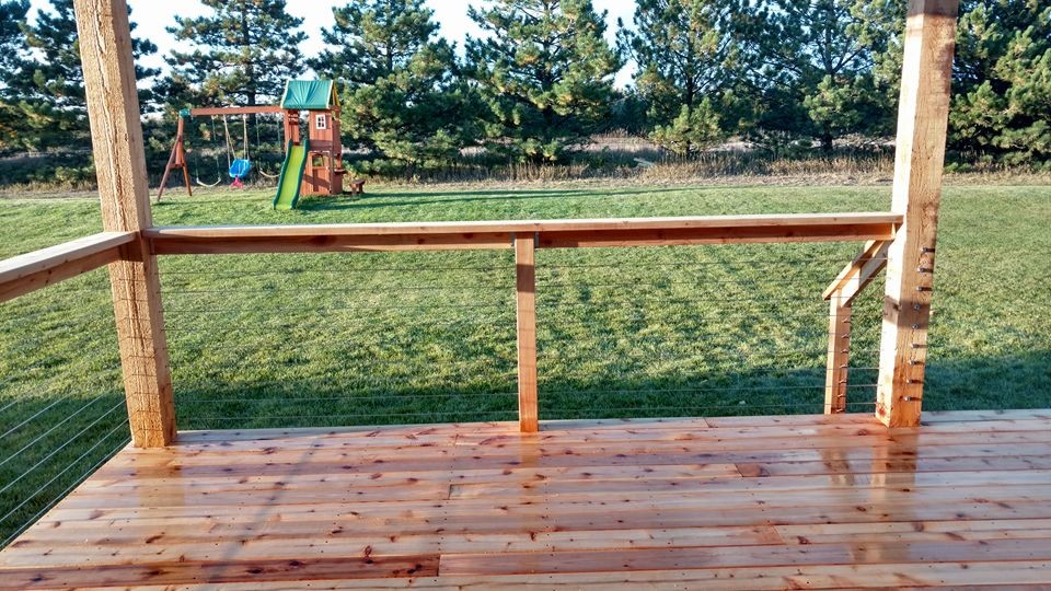 Large mountain style deck photo with a pergola