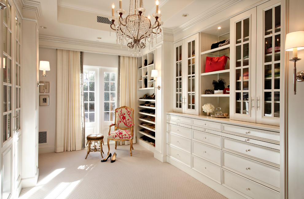Inspiration for a traditional women's dressing room in Phoenix with recessed-panel cabinets, beige cabinets, carpet and beige floor.