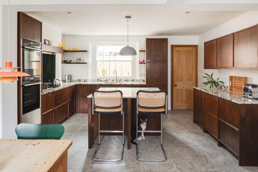 Inspiration for a midcentury u-shaped kitchen in Other with an undermount sink, flat-panel cabinets, dark wood cabinets, terrazzo benchtops, stainless steel appliances, with island, grey floor and multi-coloured benchtop.