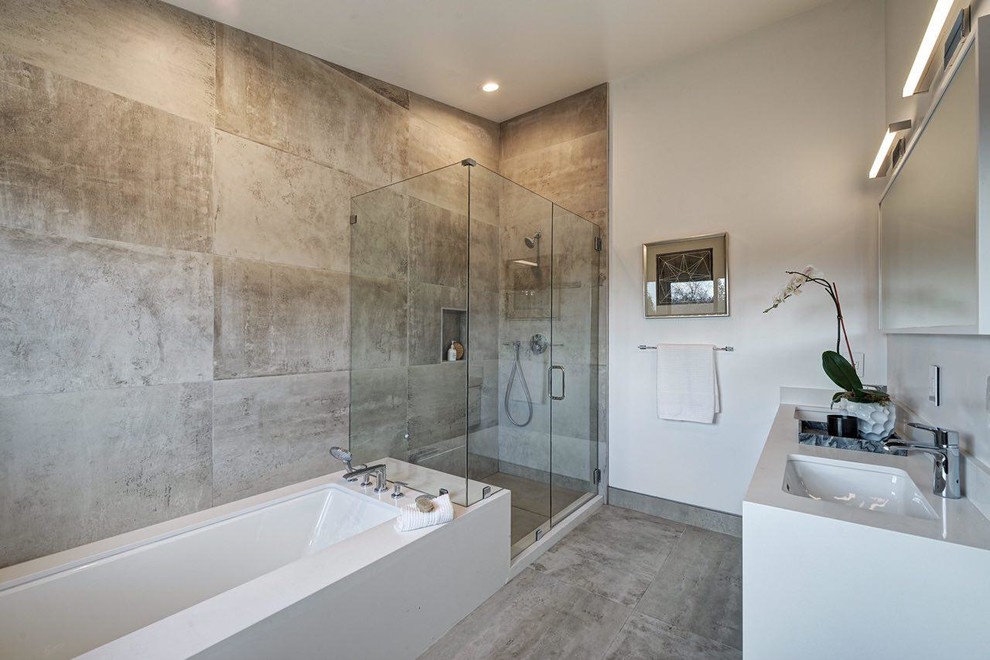 Design ideas for a mid-sized modern master bathroom in San Francisco with flat-panel cabinets, white cabinets, an undermount tub, a shower/bathtub combo, a wall-mount toilet, beige tile, porcelain tile, white walls, porcelain floors, an undermount sink, engineered quartz benchtops, beige floor and a hinged shower door.