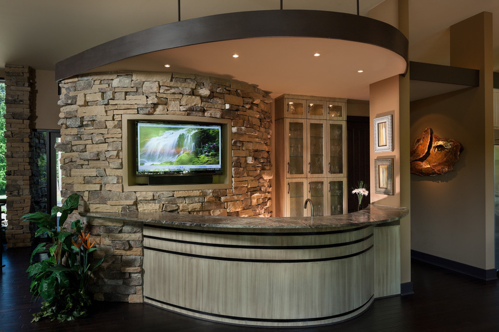 Design ideas for a large contemporary seated home bar in Other with glass-front cabinets, light wood cabinets, soapstone benchtops and dark hardwood floors.