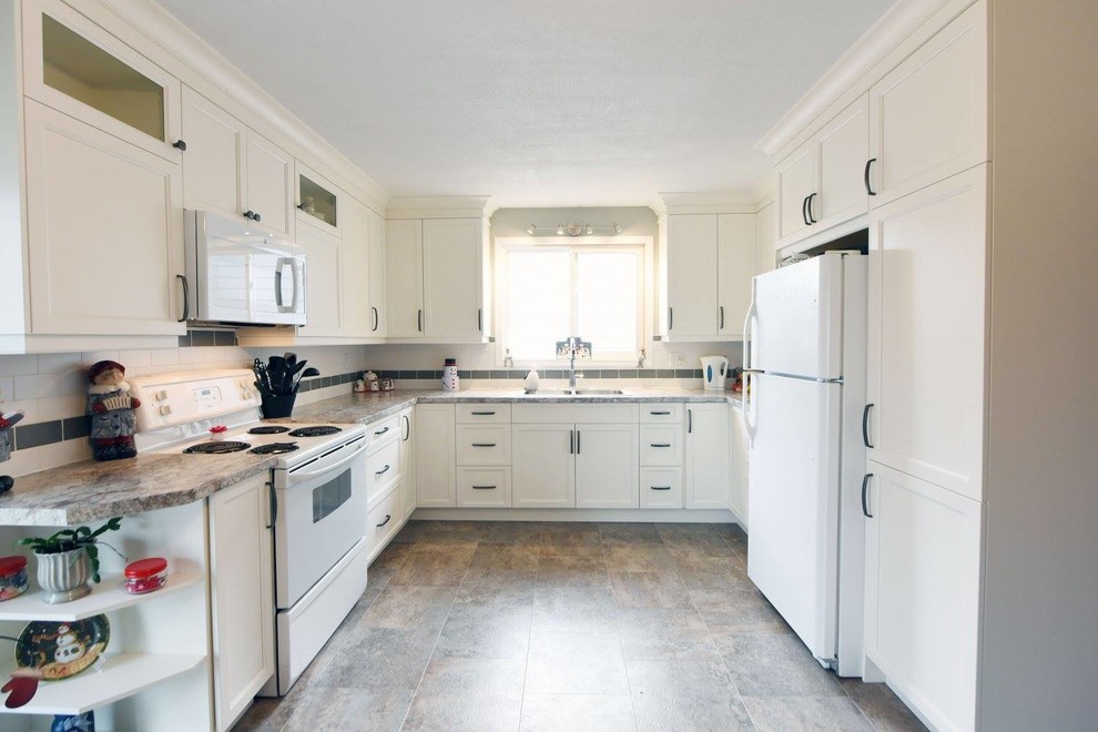 Example of a mid-sized transitional l-shaped ceramic tile eat-in kitchen design in Toronto with a double-bowl sink, recessed-panel cabinets, white cabinets, granite countertops, white backsplash, subway tile backsplash, stainless steel appliances and no island