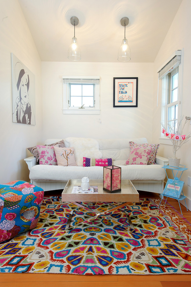 Photo of an eclectic living room in Other with white walls and medium hardwood floors.