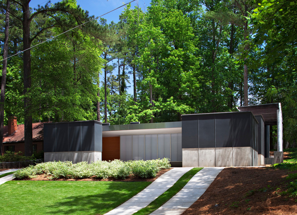 Inspiration for a mid-sized contemporary one-storey stucco black exterior in Raleigh.