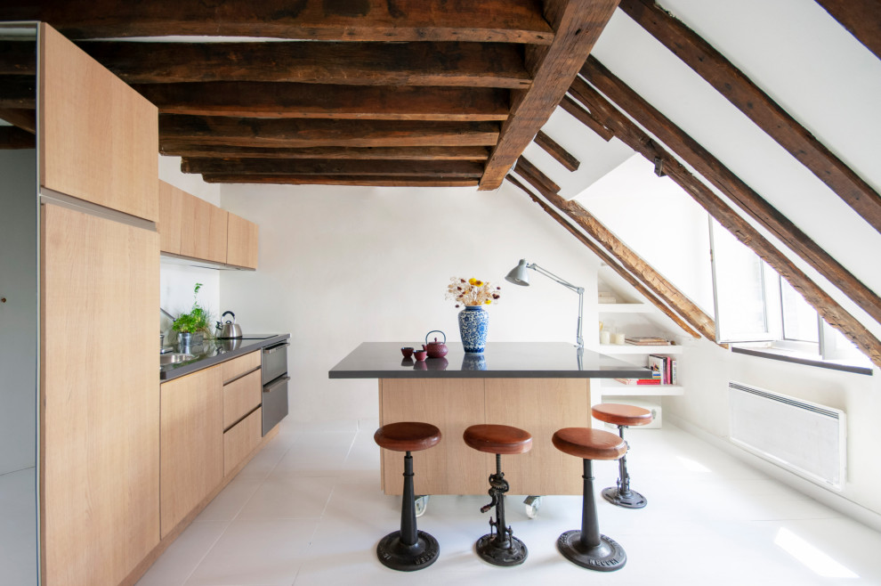 Photo of a large contemporary galley kitchen in Paris with a drop-in sink, flat-panel cabinets, light wood cabinets, solid surface benchtops, panelled appliances, porcelain floors, with island, white floor and grey benchtop.
