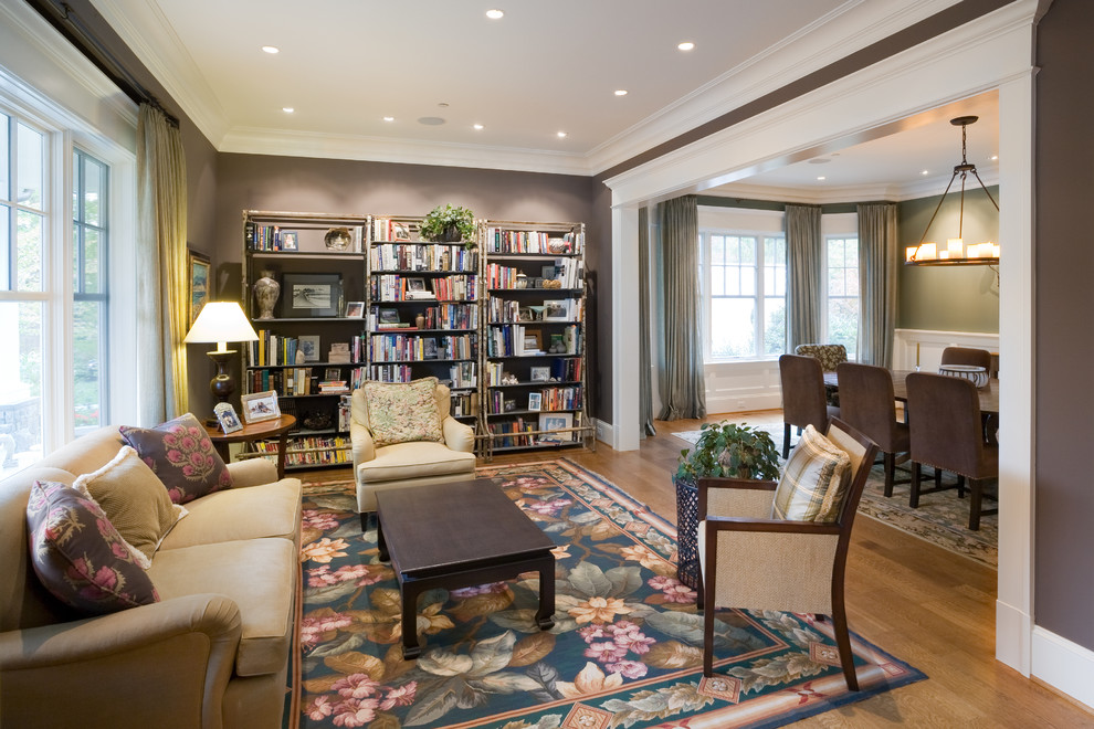Design ideas for a traditional open concept living room in DC Metro with a library, brown walls and medium hardwood floors.