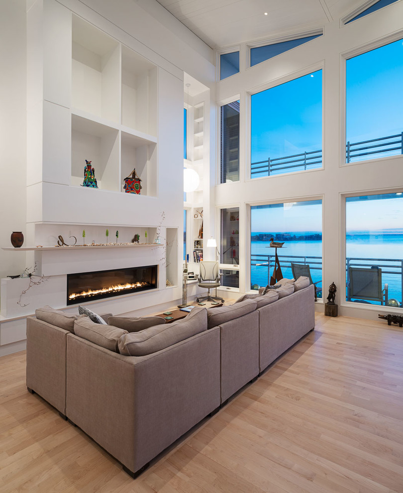 Example of a large trendy living room design in New York with white walls, a ribbon fireplace and no tv