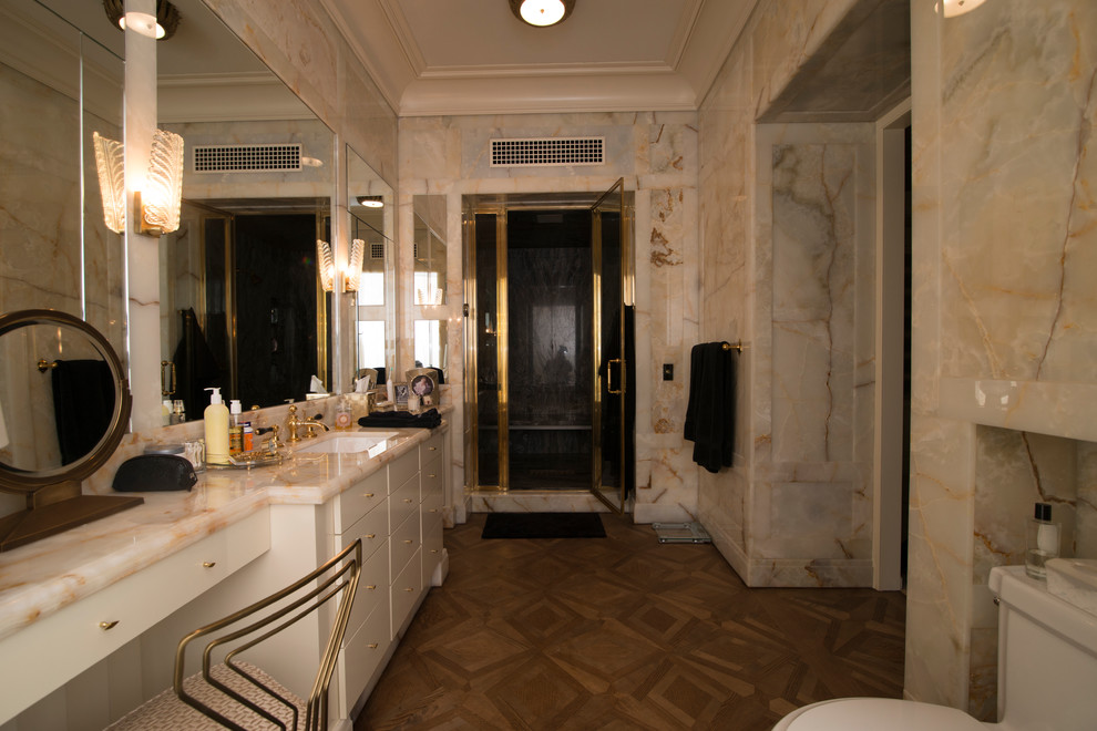 Mid-sized traditional master bathroom in Chicago with flat-panel cabinets, white cabinets, an alcove tub, an alcove shower, a one-piece toilet, stone slab, medium hardwood floors, an undermount sink and marble benchtops.