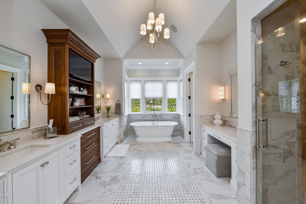 Design ideas for a large transitional master bathroom in Chicago with flat-panel cabinets, white cabinets, a freestanding tub, a double shower, white tile, porcelain tile, white walls, marble floors, an undermount sink, engineered quartz benchtops, white floor, a hinged shower door, white benchtops, an enclosed toilet, a double vanity, a built-in vanity, vaulted, decorative wall panelling and a one-piece toilet.