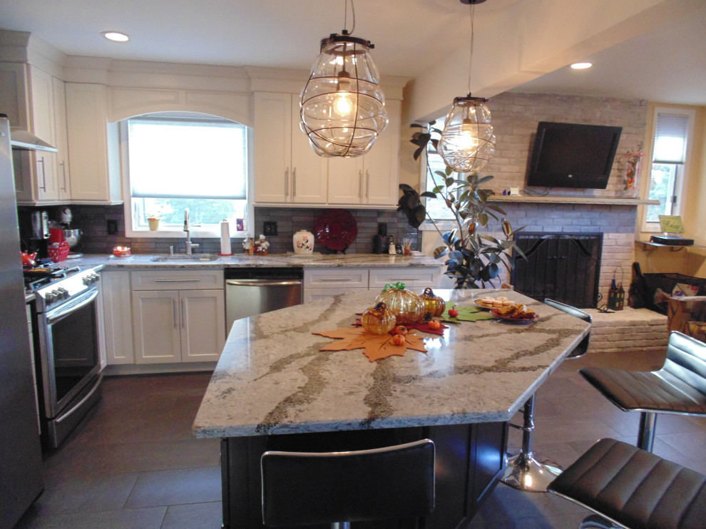 Small transitional l-shaped ceramic tile and brown floor eat-in kitchen photo with an undermount sink, recessed-panel cabinets, white cabinets, quartz countertops, gray backsplash, subway tile backsplash, stainless steel appliances, an island and gray countertops