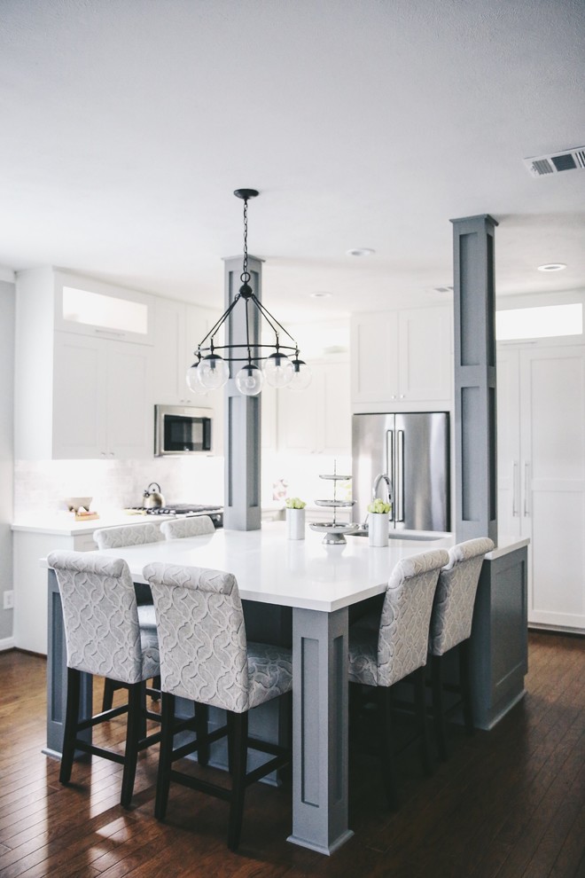 Inspiration for a transitional kitchen in Houston with shaker cabinets, white cabinets, stainless steel appliances, dark hardwood floors and with island.