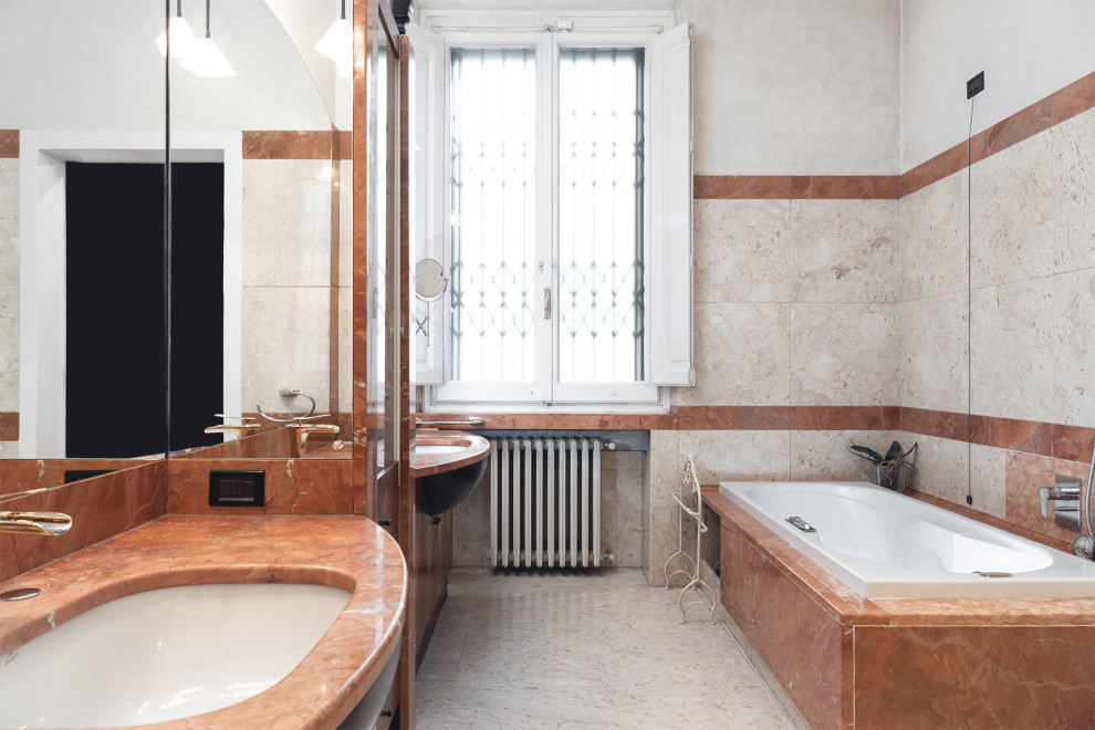 This is an example of a medium sized traditional ensuite bathroom in Florence with flat-panel cabinets, brown cabinets, a hot tub, a wall mounted toilet, beige tiles, marble tiles, white walls, marble flooring, a submerged sink, marble worktops, beige floors, brown worktops, double sinks and a built in vanity unit.