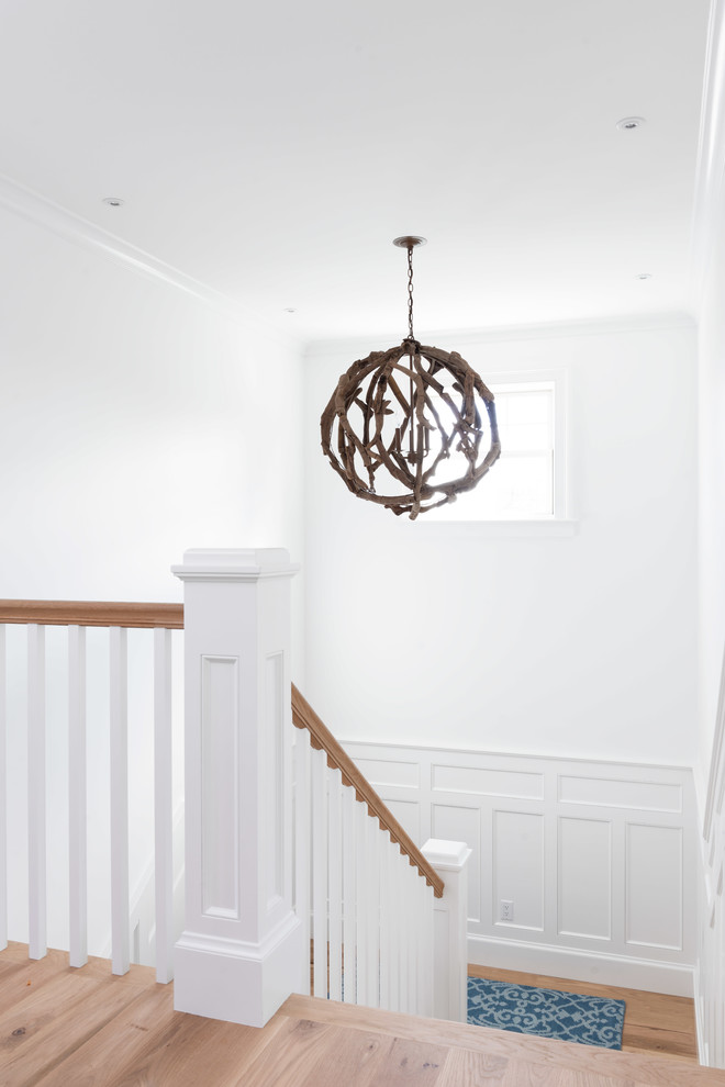 Inspiration for a transitional u-shaped wood railing staircase remodel