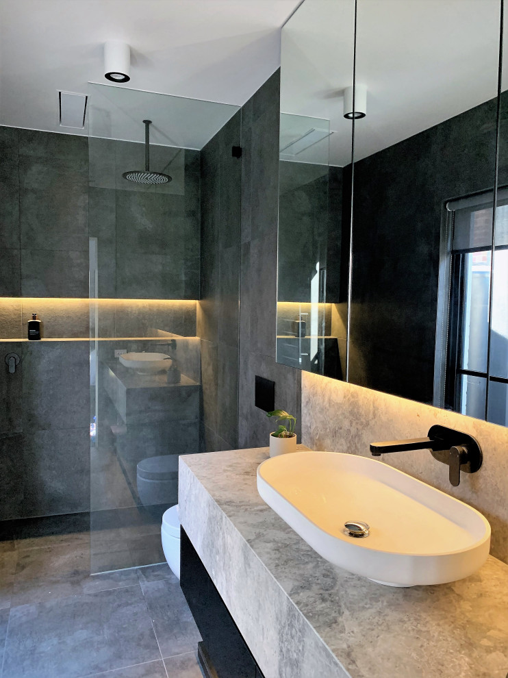 Example of a trendy gray tile and porcelain tile porcelain tile and single-sink bathroom design in Other with white cabinets, marble countertops, gray countertops and a floating vanity