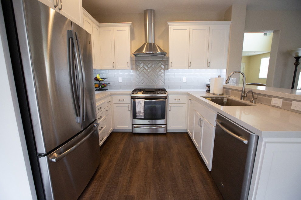 This is an example of a large modern u-shaped eat-in kitchen in Sacramento with an undermount sink, grey cabinets, quartz benchtops, grey splashback, ceramic splashback, stainless steel appliances, no island and grey benchtop.