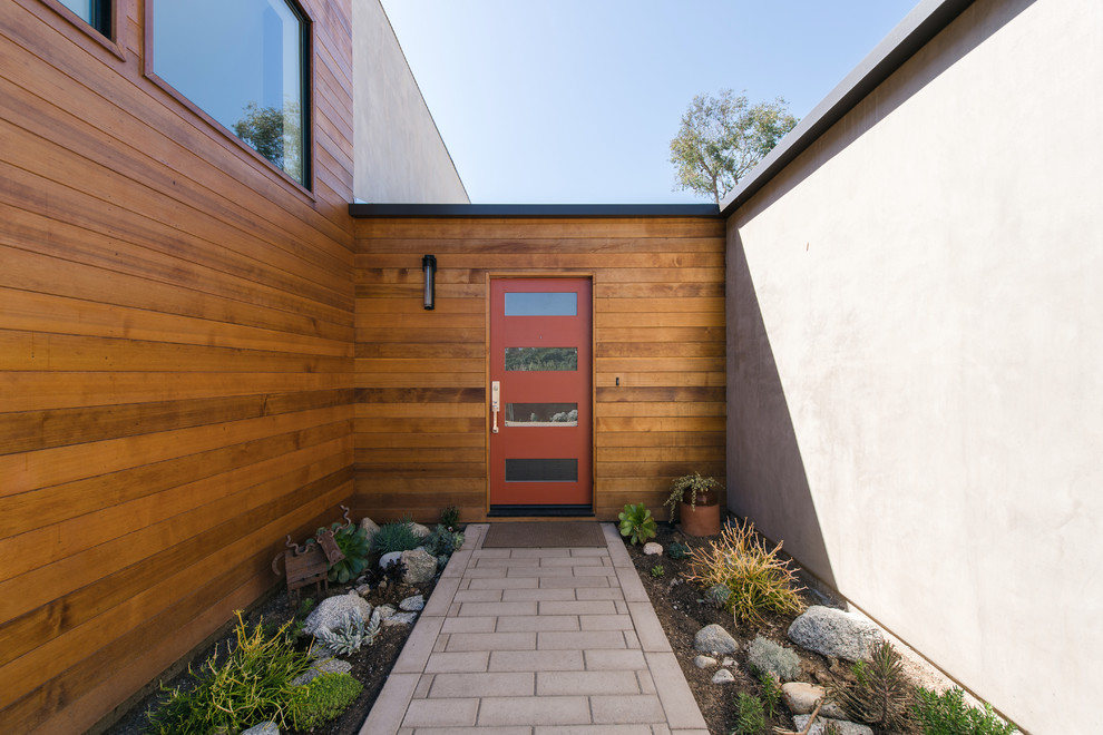 Inspiration for a mid-sized contemporary one-story gray front door remodel in Los Angeles with a shed roof, gray walls and a red front door