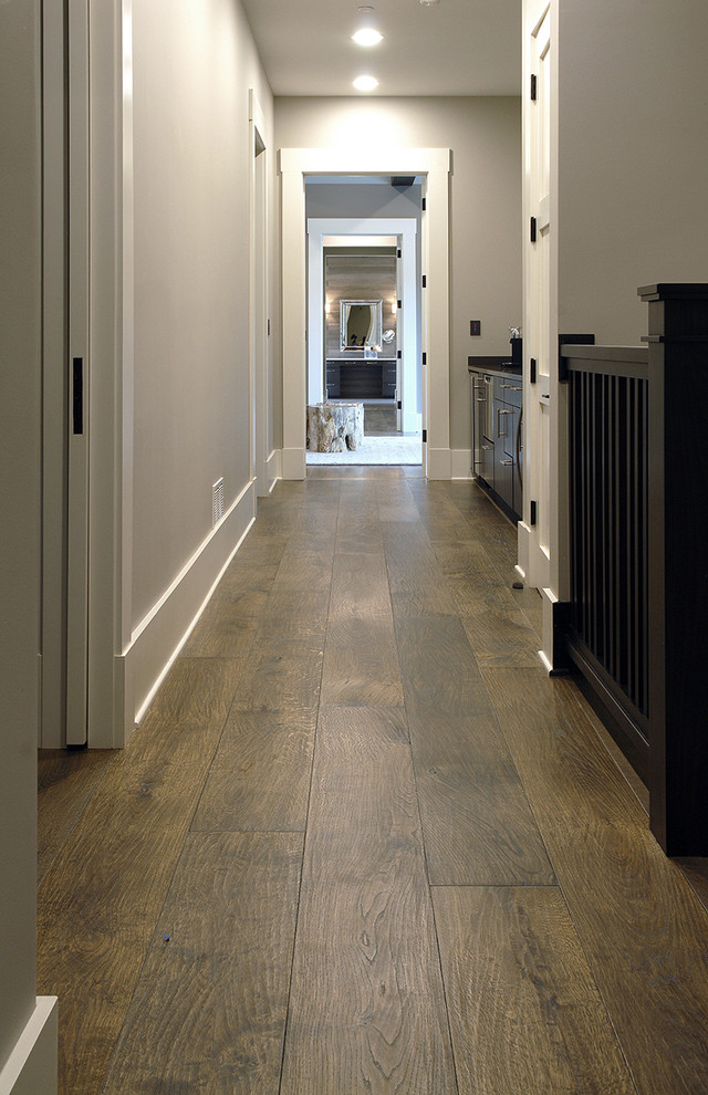 Inspiration for a huge industrial medium tone wood floor and brown floor hallway remodel in Chicago with white walls