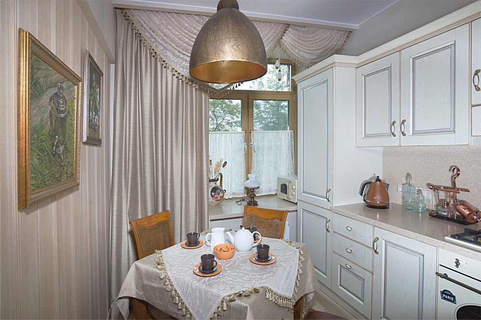 This is an example of a small traditional separate kitchen in Moscow with solid surface benchtops, beige splashback, stone slab splashback, ceramic floors and white appliances.