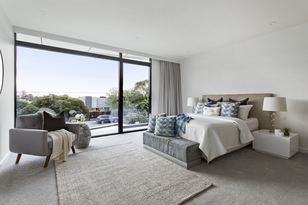 Inspiration for a contemporary bedroom in Melbourne with white walls, carpet and grey floor.