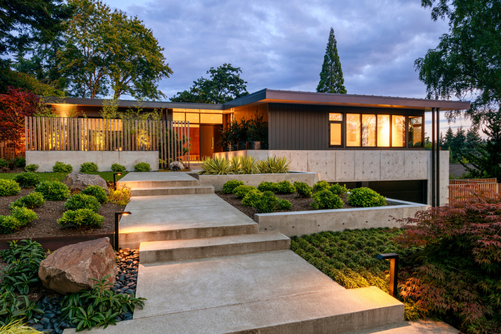 Inspiration for a midcentury two-storey grey house exterior in Seattle with a flat roof and a metal roof.