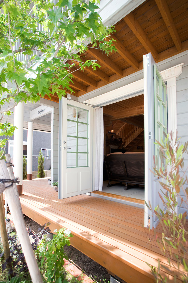 Inspiration for a mid-sized scandinavian backyard deck in Other with a roof extension.