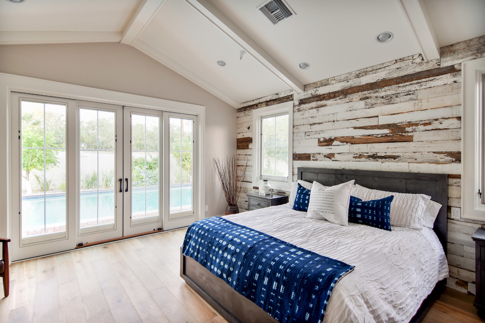 Inspiration for a large country master bedroom in Phoenix with beige walls, medium hardwood floors, no fireplace and brown floor.