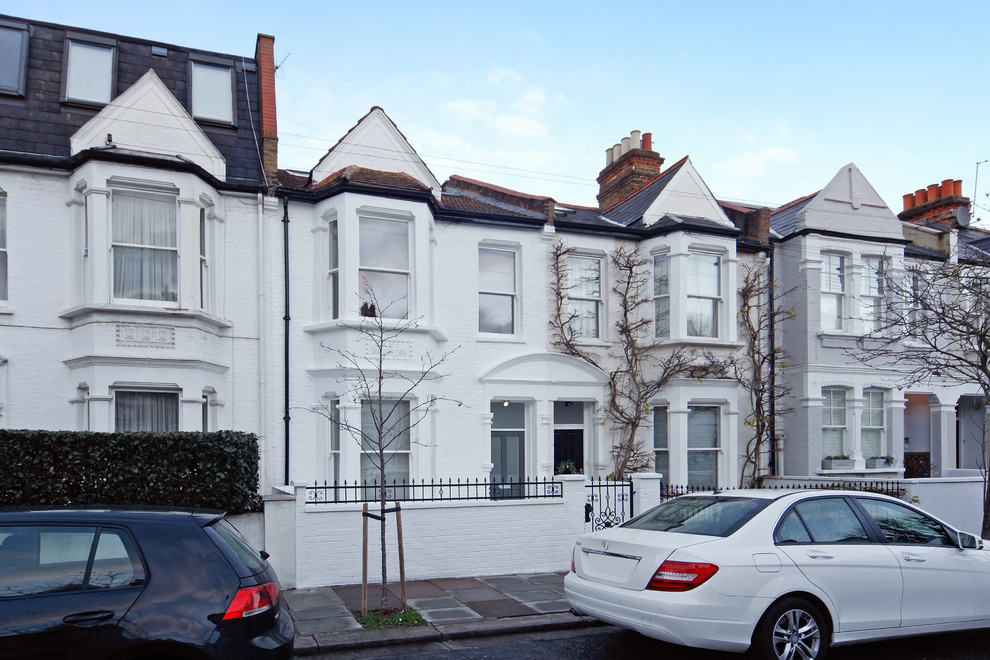 Design ideas for a large traditional three-storey brick white exterior in London.