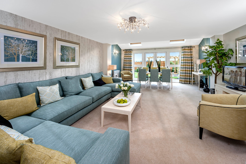 Inspiration for a transitional open concept living room in Sussex with beige walls, carpet and a freestanding tv.