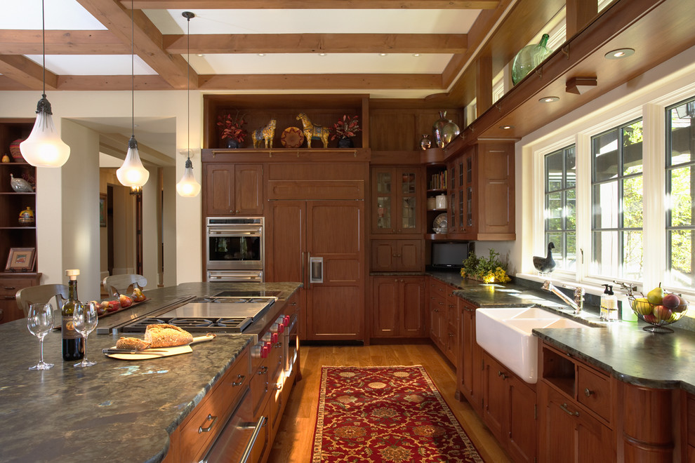 Traditional kitchen in Minneapolis with panelled appliances and a farmhouse sink.