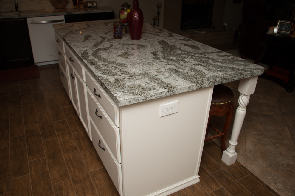 Open concept kitchen - mid-sized transitional l-shaped porcelain tile open concept kitchen idea with an undermount sink, flat-panel cabinets, dark wood cabinets, quartz countertops, beige backsplash, glass sheet backsplash, white appliances and an island
