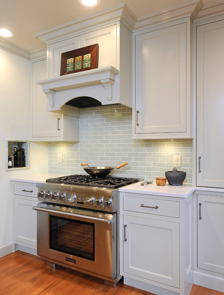 Eat-in kitchen - small transitional u-shaped medium tone wood floor eat-in kitchen idea with an undermount sink, flat-panel cabinets, gray cabinets, quartz countertops, green backsplash, subway tile backsplash, stainless steel appliances and a peninsula