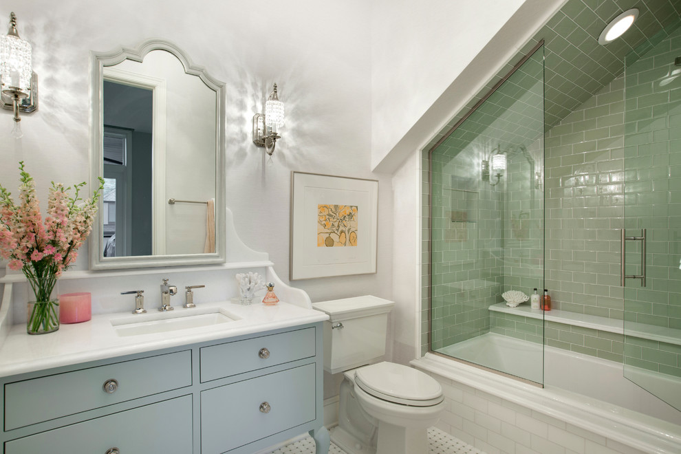 This is an example of a traditional bathroom in Minneapolis with furniture-like cabinets, grey cabinets, a drop-in tub, a corner shower, white tile, stone tile, white walls, marble floors, an undermount sink and solid surface benchtops.