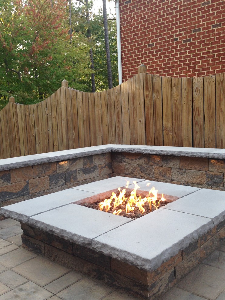 Photo of a small traditional backyard patio in Cincinnati with a fire feature, concrete pavers and no cover.