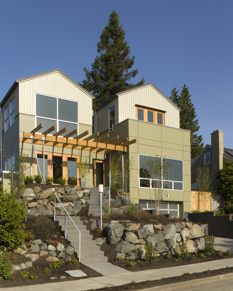 Photo of a contemporary two-storey green exterior in Seattle with a gable roof.