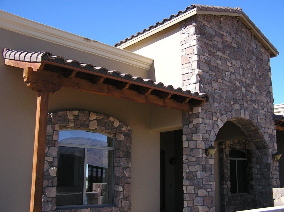Example of a mid-sized tuscan concrete floor and gray floor front door design in Phoenix with brown walls