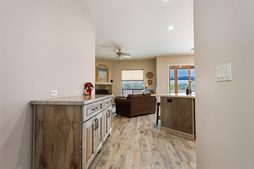 Example of a large transitional u-shaped porcelain tile and gray floor open concept kitchen design in Phoenix with an undermount sink, flat-panel cabinets, beige cabinets, wood countertops, stainless steel appliances, an island and beige countertops