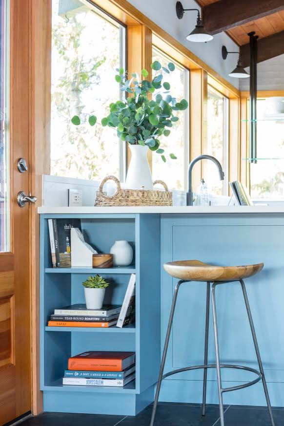 Inspiration for a large modern u-shaped kitchen in Seattle with a farmhouse sink, shaker cabinets, blue cabinets, quartzite benchtops, white splashback, subway tile splashback, stainless steel appliances, slate floors, a peninsula, black floor and white benchtop.