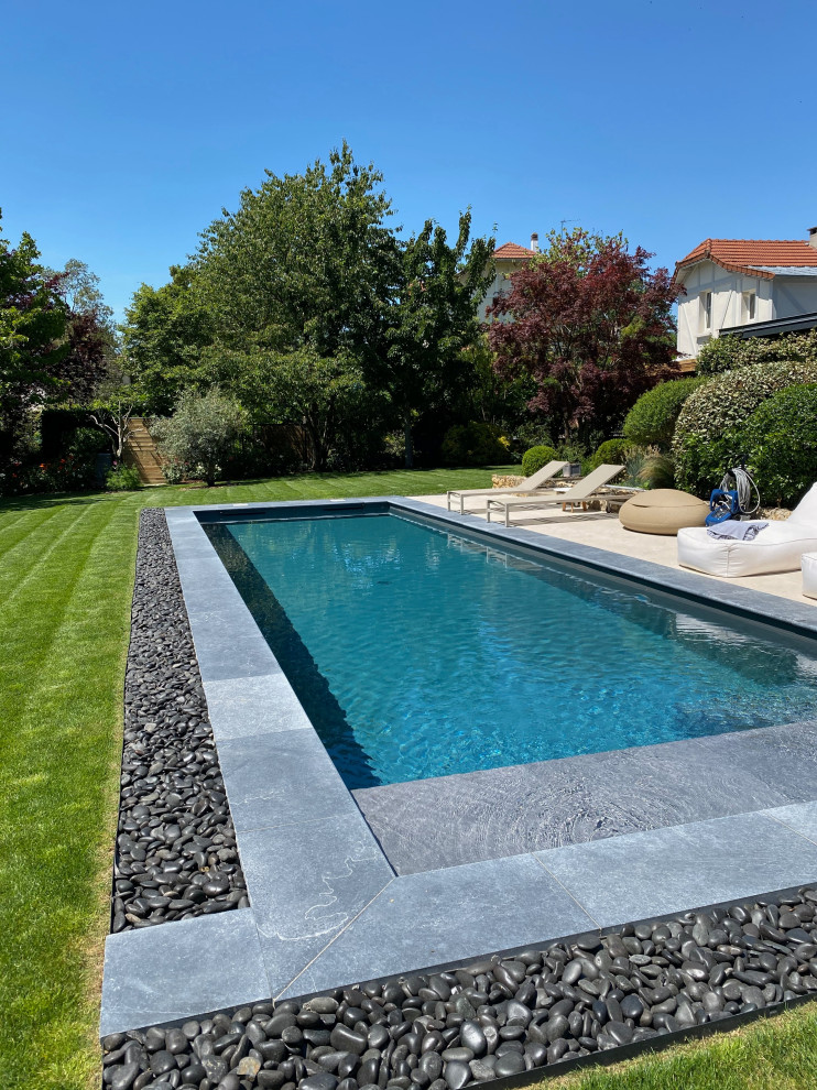 Modelo de piscina alargada actual de tamaño medio rectangular en patio trasero
