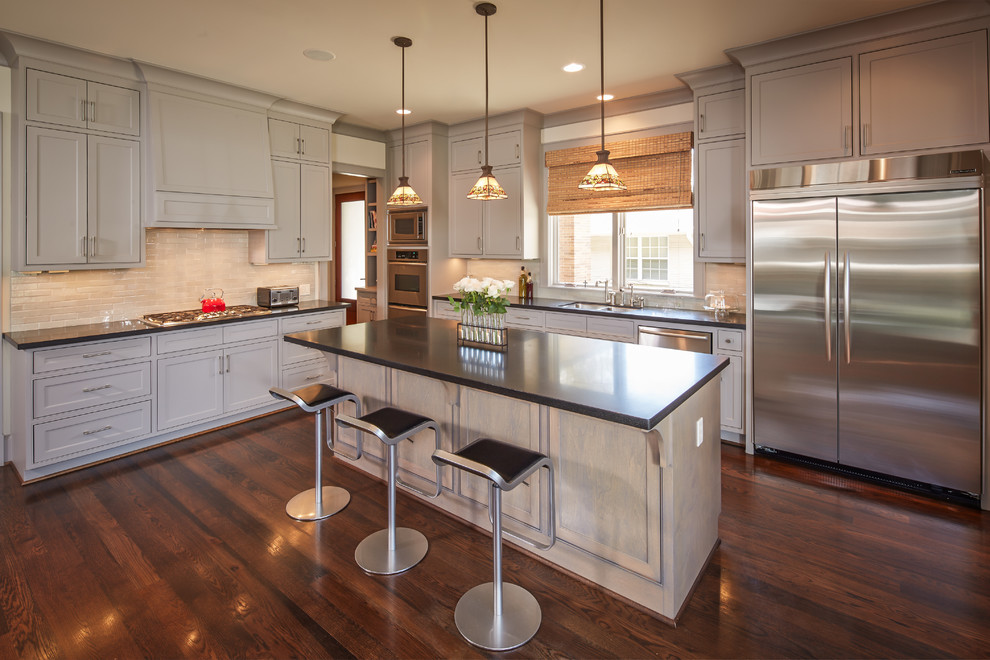Inspiration for a large traditional l-shaped eat-in kitchen in Houston with recessed-panel cabinets, grey cabinets, beige splashback, stainless steel appliances, a double-bowl sink, dark hardwood floors and with island.
