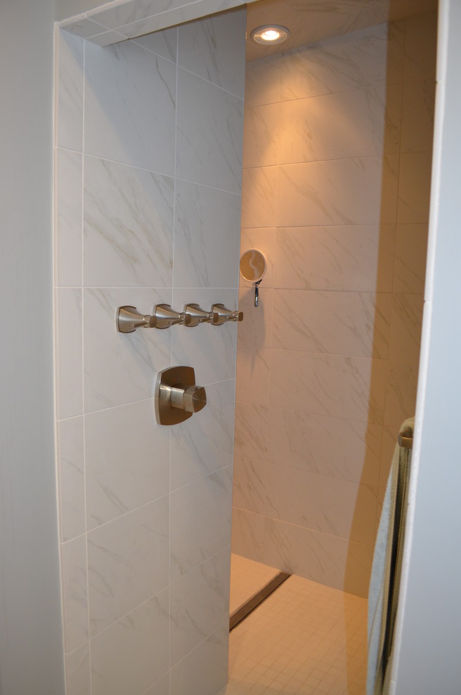 Inspiration for a mid-sized transitional master bathroom in Boston with an undermount sink, recessed-panel cabinets, engineered quartz benchtops, a one-piece toilet, porcelain floors, medium wood cabinets, an open shower, brown tile, gray tile, matchstick tile, grey walls, beige floor and an open shower.
