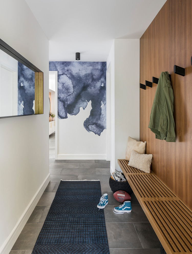 This is an example of a contemporary hallway in Boston with white walls, ceramic floors, grey floor and wood walls.