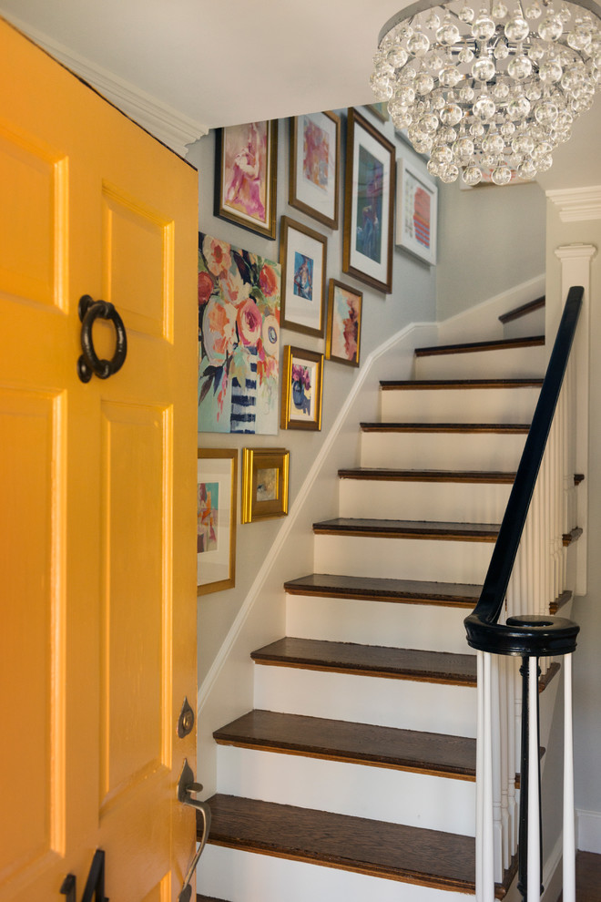 This is an example of a mid-sized contemporary wood straight staircase in Boston with painted wood risers and wood railing.