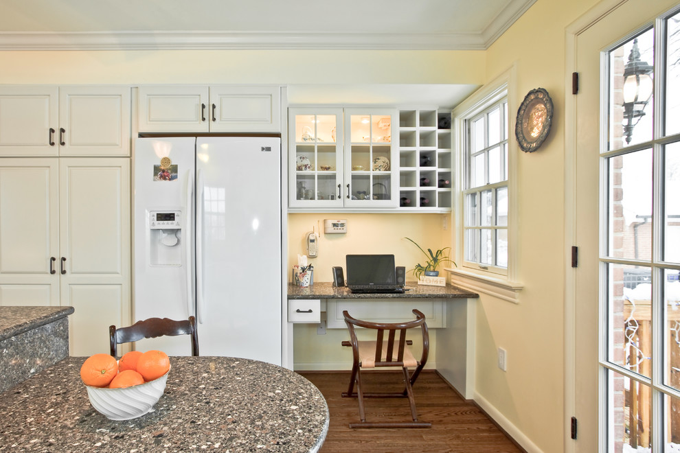 Photo of a mid-sized traditional single-wall open plan kitchen in DC Metro with raised-panel cabinets, white cabinets, quartz benchtops, white appliances, medium hardwood floors and with island.
