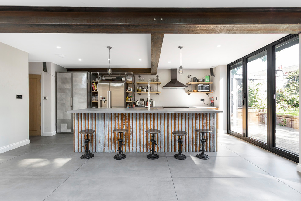 Design ideas for a large industrial galley eat-in kitchen in London with an integrated sink, flat-panel cabinets, medium wood cabinets, concrete benchtops, brick splashback, stainless steel appliances, concrete floors, with island and grey floor.