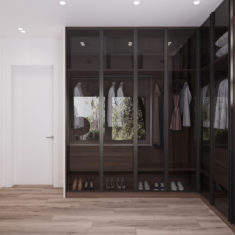 This is an example of a large contemporary built-in wardrobe for women in Other with glass-front cabinets, black cabinets, medium hardwood flooring and beige floors.