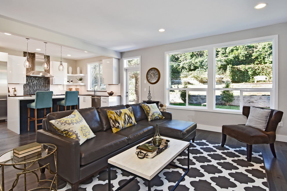Photo of a transitional open concept living room in Seattle with grey walls and dark hardwood floors.
