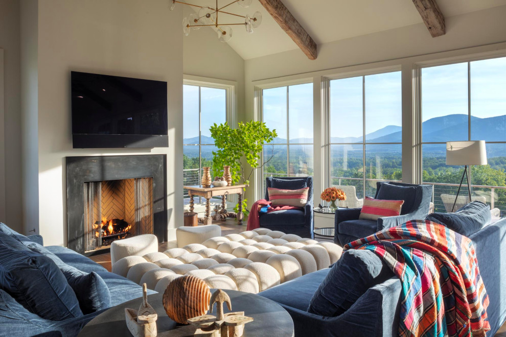 Huge transitional open concept porcelain tile, brown floor and exposed beam living room photo with beige walls, a standard fireplace, a tile fireplace and a wall-mounted tv