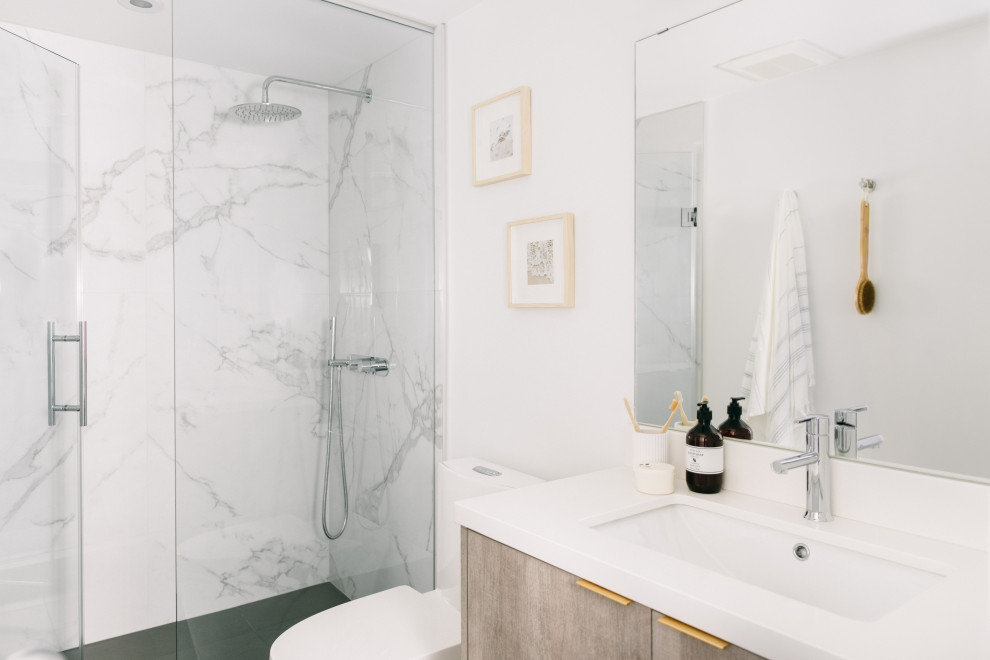 Inspiration for a small modern 3/4 multicolored tile and porcelain tile porcelain tile and gray floor alcove shower remodel in Toronto with flat-panel cabinets, light wood cabinets, a one-piece toilet, white walls, an undermount sink, quartz countertops, a hinged shower door, white countertops and a built-in vanity