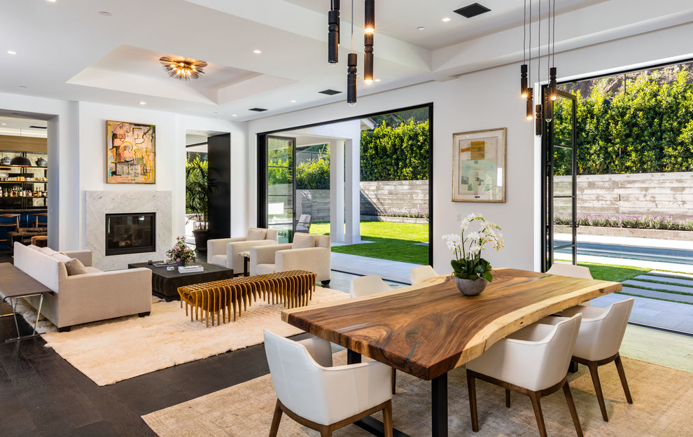 Inspiration for a large contemporary open plan dining in Los Angeles with white walls, dark hardwood floors, no fireplace and brown floor.
